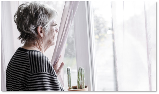 Vrouw kijkt triest uit het raam